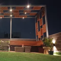 A perfect evening setting on a completed terrace project. This space features a custom-built pergola with an integrated bench, artificial turf, and carefully placed lighting to create a warm and inviting atmosphere.