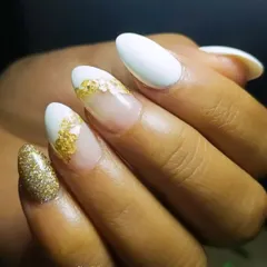 At my studio, perfection is key. This design features a white base with gold foil and a full-coverage gold glitter accent nail. It's glamorous without being over the top.