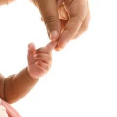 The simple, powerful moment of a newborn's hand wrapped around a parent's finger. A classic shot that symbolizes connection and trust.