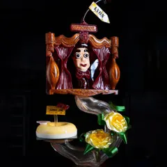 Another view of the award-winning Guignol showpiece, highlighting the intricate sugar work in the yellow roses and the detailed chocolate sculpting of the puppet theater.