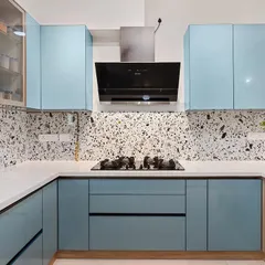 This kitchen features a beautiful combination of powder blue cabinets and a terrazzo-style backsplash. It’s a great example of how to use color and pattern to create a kitchen with personality.