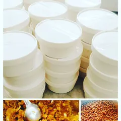 This shows our process for a bulk order. The food, like this halwa and chana, is cooked in large quantities and then packed into clean, sealed containers, ready for delivery to an office or event.
