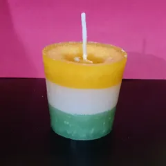 A handmade votive candle with layers of saffron, white, and green, inspired by the Indian flag. This is perfect for national holidays or just to show some patriotic pride.