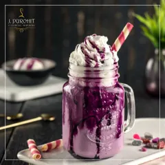 For those with a sweet tooth, I offer a range of dessert shakes that are both a drink and a treat. This Black Grape smoothie, served in a rustic mason jar, is topped with rich whipped cream and a colorful wafer straw. It's a popular choice for adding a fun and indulgent element to parties and family gatherings.