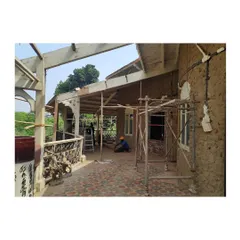 The veranda mid-restoration, showcasing the new flooring being laid and the roof structure taking shape. This phase requires a delicate balance of new construction and integration with the existing historic elements.