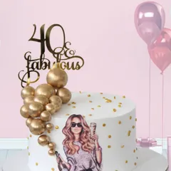Celebrating "40 & Fabulous" with champagne and style. This chic cake features an edible print of a glamorous woman, accented with a cascade of edible gold spheres and a sparkling topper.