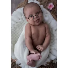 A touch of whimsy can create such a fun and memorable portrait. These tiny round glasses add a playful and studious charm to this little one's expressive face.