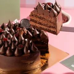 The perfect slice pull from a decadent chocolate cherry cake. Capturing the texture and layers is key to making desserts look as delicious as they taste.