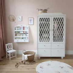 A charming and practical wardrobe and bookshelf combination designed specifically for a child's room. The classic white finish and intricate lattice-work on the doors provide a timeless look, while ensuring all storage needs are met.