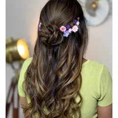 A new trend for the upcoming bridal season: a soft half-updo adorned with real pressed flowers.