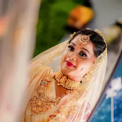 The beautiful dimple in her smile says it all. This bride's reflection shows a woman who is happy, confident, and ready to celebrate her wedding day.