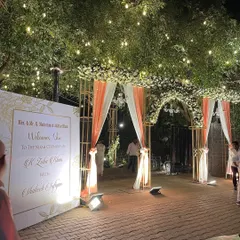 A grand and welcoming entrance to a Nikah ceremony, adorned with white and peach flowers and drapery. This sets a beautiful tone for the blessed union of the couple.