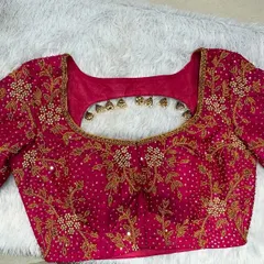 A beautiful pink bridal blouse with all-over gold zardosi work and a simple back cutout, perfect for a classic bridal look.