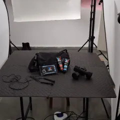 A wide shot of our studio setup for a fitness product shoot. You can see the textured mat, lighting equipment, and diffusers we used to create the final dark and moody look.