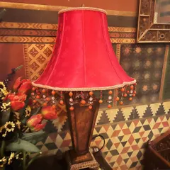 Sourcing unique pieces is a major part of my process. I found this vintage red lamp on a sourcing trip, and it now adds a perfect pop of color to a client's den. A single, well-chosen object can completely elevate the mood of a room.