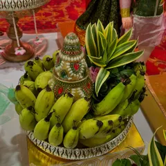 A traditional 'Phala Tambula' platter. This arrangement features a decorative cone surrounded by fresh bananas, symbolizing abundance and prosperity for the occasion.