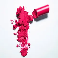 This top-down shot shows a smashed lipstick smear, creating a raw and artistic representation of the product's color and texture. It's a great way to create compelling beauty imagery that goes beyond a simple product photo.