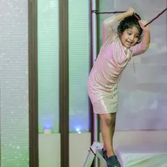 A young adventurer tackles the rope swing in the indoor play zone. These setups are perfect for burning off energy and encouraging active play.