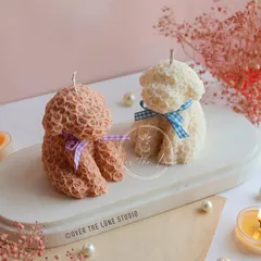 A duo of Rose Puppy candles in beige and white. These are a wonderful gift for any dog lover.
