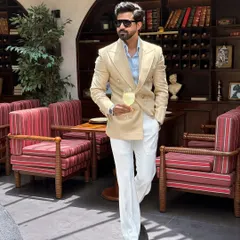 Captured in motion, this image shows the impeccable drape and fit of our tailored blazer and trousers. It’s a look that is both commanding and effortlessly cool.