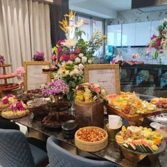 A magnificent grazing table set up for a private housewarming celebration. This spread includes everything from artisanal chocolates and Indian mithais to savoury snacks and fresh fruit, offering something for every palate.