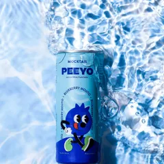 A refreshing shot of a blueberry mojito can submerged in clear, rippling water, perfectly capturing a feeling of cool, summer refreshment.