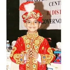 A photo of me as a young boy in a traditional performance costume. From the very beginning, I loved dressing up and putting on a show for an audience.