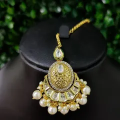 Another elegant chaand bali style maang tikka with a polished gold finish and pearl accents.