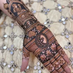 A full view of a stunning Teej henna design, featuring a royal portrait, elephants, and a central peacock motif on the palm.