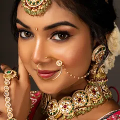 A close-up from a bridal portfolio shoot, focusing on the flawless makeup and intricate Kundan jewellery. I use lighting that makes the skin glow and brings out the richness of the traditional look.