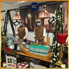 Our staff at a beautifully decorated beverage counter. The setup includes a boat-shaped ice bucket for water bottles and artisanal drink dispensers, showcasing our creative and thematic approach to service stations.