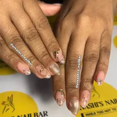 A delicate and dreamy manicure featuring a soft pink base with gold accents. I added personalized initials, a tiny ring charm, and a sprinkle of glitter for a charming and romantic feel.