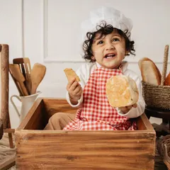 How adorable is this little baker? Themed shoots are one of my favorite things to do. For this first birthday session, we created a mini bakery with real bread, a chef's hat, and lots of wooden props for him to play with.
