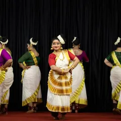 A lead dancer takes center stage, surrounded by the ensemble, demonstrating the blend of solo and group work within our full-length shows.