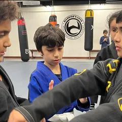 Students practice techniques on each other, learning through doing. This partner drill focuses on grip fighting, a fundamental skill in Jiu-Jitsu for controlling an opponent.
