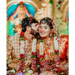 A candid moment of pure bliss as the couple is showered with flowers by their loved ones during their wedding ceremony.