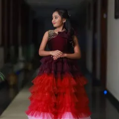 I designed this multi-layered gown with shades of wine, red, and pink for a special 10th birthday party. The bodice features delicate beadwork for an extra touch of sparkle.