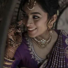 A playful and candid moment from an engagement ceremony. The makeup is subtle and elegant, designed to look beautiful in natural light and capture the bride's joyful spirit.
