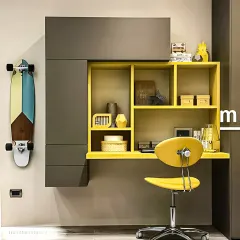 We used a bold color-blocking technique for this compact study unit, combining charcoal grey cabinetry with a vibrant yellow desk and shelving. This wall-mounted design saves floor space while making a strong visual statement.