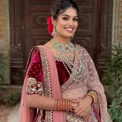 A radiant smile for a joyous Sangeet night. This look features glowing skin and defined kohl eyes, paired with a modern messy updo, creating a perfect blend of royal grace and contemporary magic.