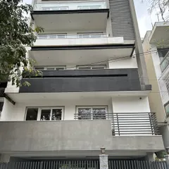 The completed exterior of a builder floor project in CR Park, New Delhi. For this project, we provided architectural consultancy, resulting in a clean, contemporary facade with contrasting grey and white tones.