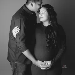 A quiet, tender moment between expecting parents. This black and white portrait beautifully captures the love and anticipation in their expressions.