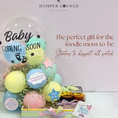 For the foodie mom-to-be, this hamper is the perfect indulgence. I arranged for a complete meal from her favorite restaurant, Yauatcha, including starters, mains, and desserts, and presented it with festive balloons and decorations for her baby shower.