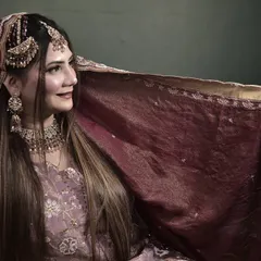 The bride's long, sleek hair provides a beautiful canvas for the traditional jewelry. This look is both modern and timeless.