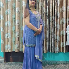 A beautiful periwinkle blue sharara set. The kurta is detailed with delicate embroidery, and the pleated sharara pants add a touch of modern flair.