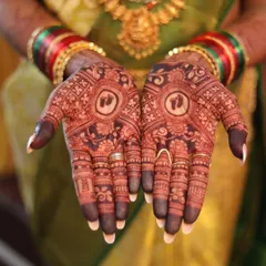 A professionally captured photo of the final baby shower mehendi stain. The deep color highlights the intricate details surrounding the central baby feet motif.