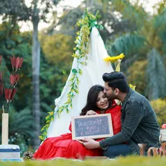 A candid moment from an outdoor couple's maternity shoot. We set up a cozy teepee picnic scene, and this sweet kiss captures the genuine joy and anticipation of their journey together.