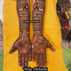 A beautiful example of a non-figurative bridal design. This piece focuses on intricate patterns, floral motifs, and a procession of elephants on the arms.