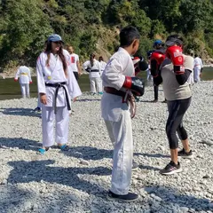 An outdoor training session with students on a riverbank. Taking our practice into the elements helps build mental toughness and adaptability, key traits for any martial artist.