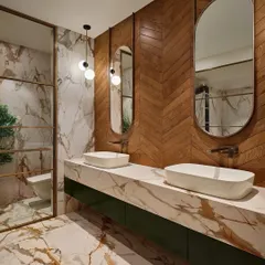 A luxurious master bathroom featuring a mix of materials. The walls combine herringbone wood paneling with dramatic, gold-veined marble, which is also used for the double vanity countertop.